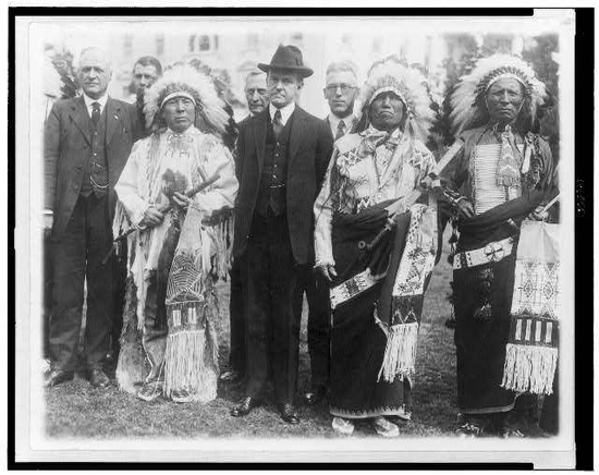 President Calvin Coolidge poses with unidentified tribal leaders after the signing of the Indian Citizenship Act of 1924.