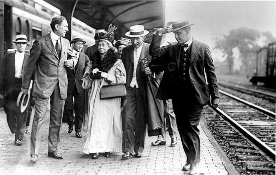 Standard Oil Co. founder John D. Rockefeller (with cane) escorts sister-in-law Lucy Spelman through Coit Rd. Station in East Cleveland, en route to Rockefeller's Forest Hill summer home, 1912. 