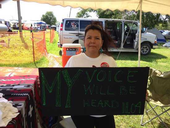 South Datkota woman holds up sign that says 