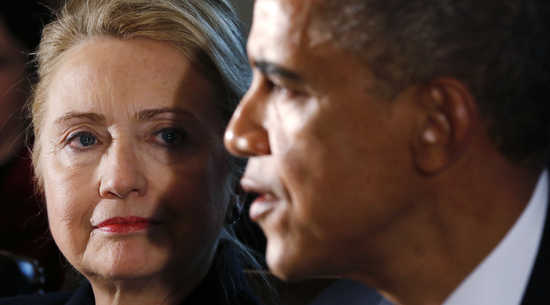 U.S. Secretary of State Hillary Clinton (L) listens to U.S. President Barack Obama speak during a meeting with members of his cabinet at the White House in Washington November 28, 2012. Obama said on Wednesday he hopes he can reach agreement with the U.S. Congress before Christmas to avoid the looming 