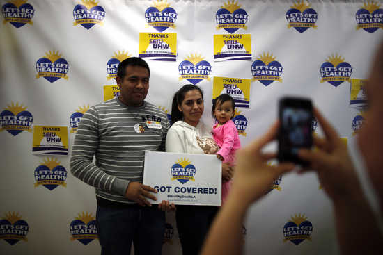 Enrique Gonzalez, 22, (L-R), Janet Regalado, 21, and their nine-month-old daughter Kayleen Gonzalez pose for a photo after signing up for health insurance at an enrolment event in Commerce, California March 31, 2014. U.S. President Barack Obama's embattle