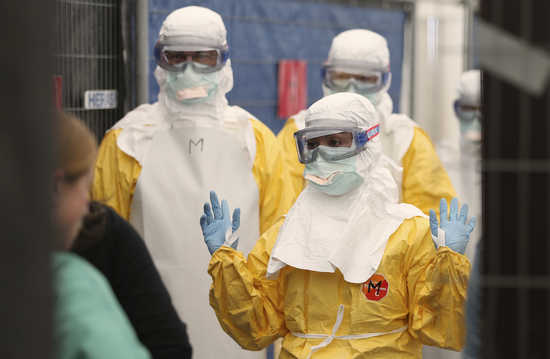 Volunteers for Medecins Sans Frontieres (MSF), or Doctors Without Borders, receive training on how to handle personal protective equipment during courses in Brussels October 15, 2014, which is aimed to help deal with the Ebola disease in West Africa. The 