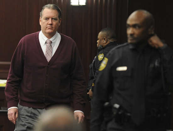 Michael Dunn returns to the courtroom during jury deliberations in his murder trial over the killing of Jordan Davis, in Jacksonville, Florida February 13, 2014. Dunn is accused of first degree murder in the death of unarmed teenager Davis after an alterc