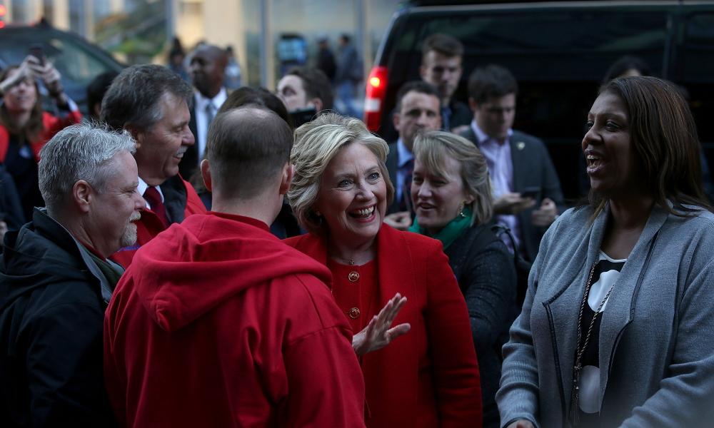 Hillary Clinton greets picketing Verizon workers outside of a Verizon store in New York City.
