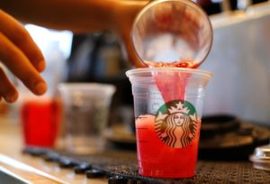 A barista pours a drink at a newly designed Starbucks coffee shop in Fountain Valley, California